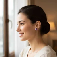model wearing silver studs with 7x9 mm oval Amethyst and cubic zirconia