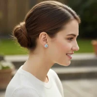 model wearing silver studs cluster with 6mm round Blue Topaz and cubic zirconia