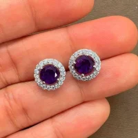 silver studs cluster with 6mm round Amethyst and cubic zirconia displayed in hand