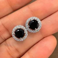 silver studs cluster with 6mm round Black Onyx and cubic zirconia displayed on hand