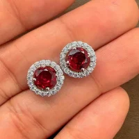 silver studs cluster with 6mm round Garnet and cubic zirconia displayed on hand