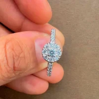 silver ring cluster with 3mm round cubic zirconia displayed on hand