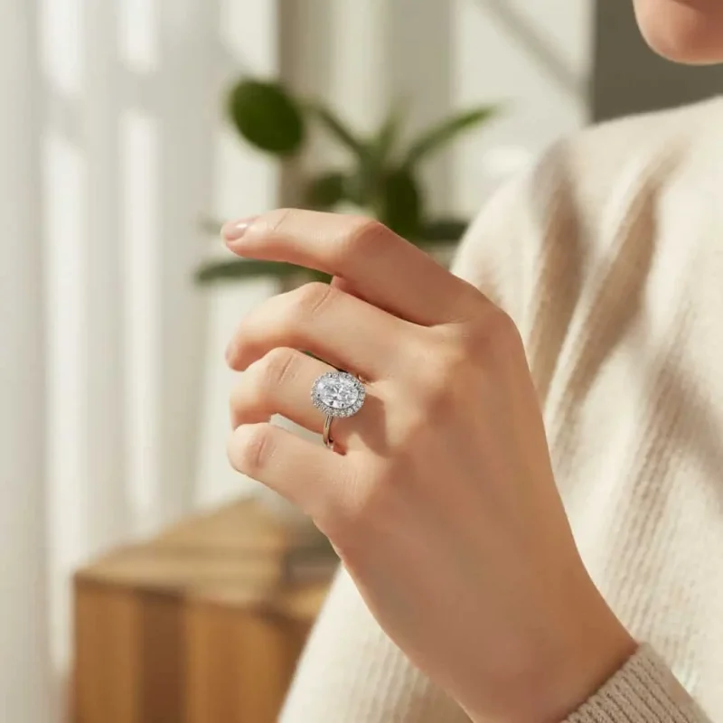 model wearing silver ring cluster with 7x9 mm oval cubic zirconia