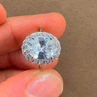 silver ring cluster with 7x9 mm oval cubic zirconia displayed on hand