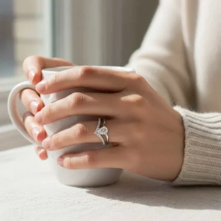 model wearing silver ring with cubic zirconia with 4x6 mm pear shaped zirconia