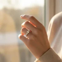 model wearing Silver Ring with 5mm round shaped Cubic Zirconia and small round Cubic Zirconia