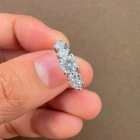 Silver Ring with 5mm round shaped Cubic Zirconia and small round Cubic Zirconia displayed on hand