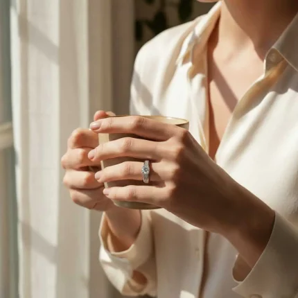 model wearing silver ring with cubic zirconia with 5 mm round shaped zirconia
