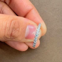 Silver Ring with small round Cubic Zirconia Half Challa design displayed on hnad