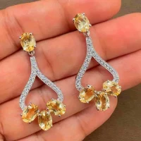 5x7 mm oval shaped Citrine Gemstone and Cubic Zirconia displayed on hand