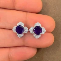 Silver Studs flower shaped with 6mm round shaped Amethyst Gemstone and Cubic Zirconia displayed on hand