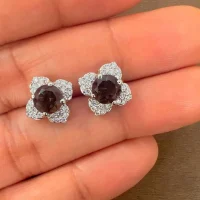 Silver Studs flower shaped with 6mm round shaped Smoky Quartz Gemstone and Cubic Zirconia displayed on hand