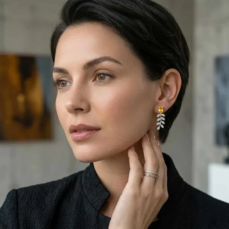 model wearing silver earrings gemstones with 5x7 mm oval citrine