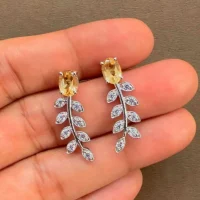 silver earrings gemstones with 5x7 mm oval citrine displayed on hand