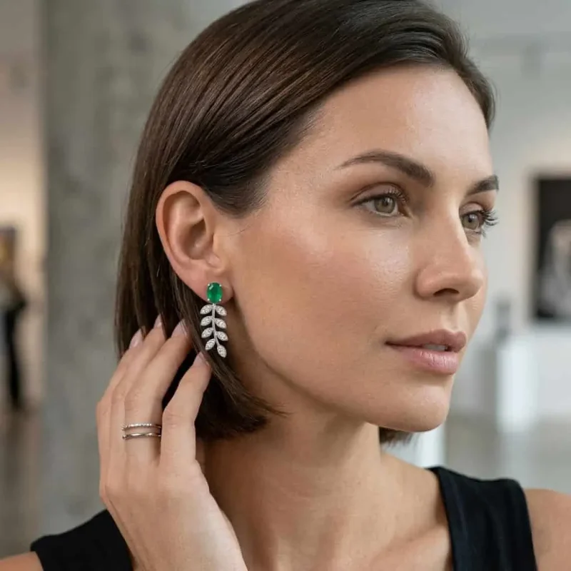 model wearing silver earrings gemstones with 5x7 mm oval green onyx