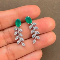 silver earrings gemstones with 5x7 mm oval green onyx displayed on hand