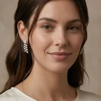 model wearing silver earrings gemstones with 5x7 mm oval cubic zirconia