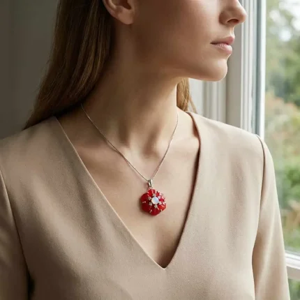 model wearing silver pendant with carved flower red onyx gemstone with rainbow moonstone and cubic zirconia