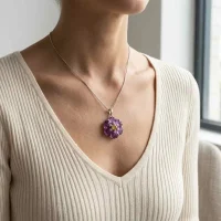 model wearing silver pendant with carved flower amethyst gemstone with citrine and cubic zirconia